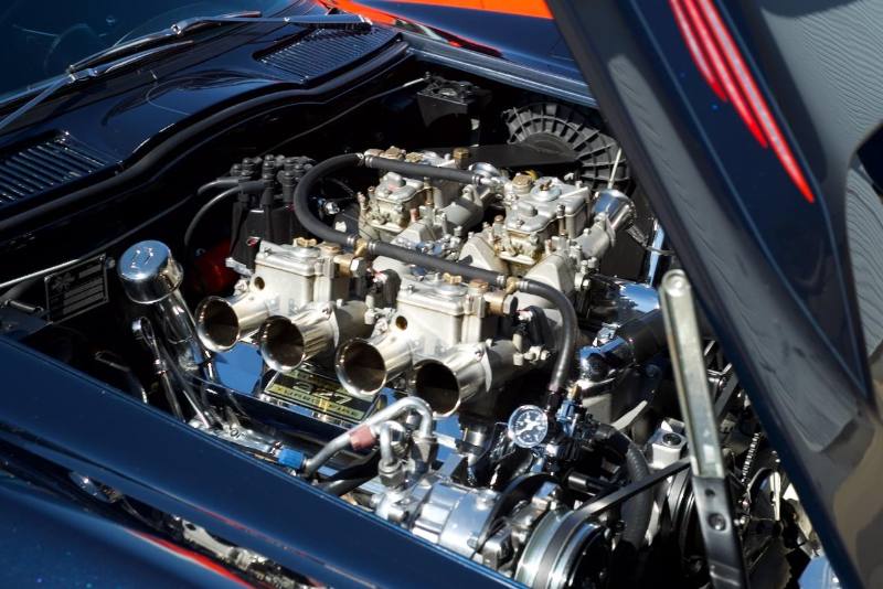 Engine bay with a row of carburetors