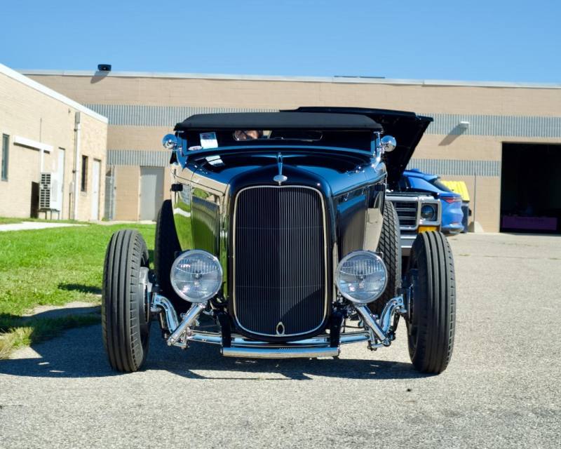 Black roadster, head-on
